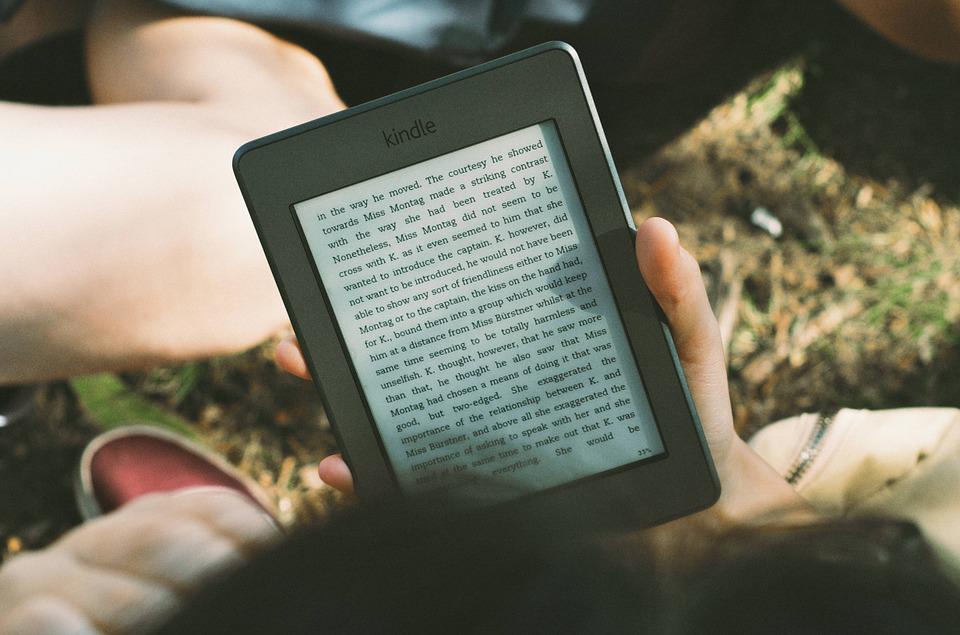 Make money online - Picture of a person reading an Ebook on their Kindle